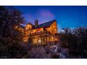 Log cabin exterior with stone foundation and deck at 276 Seven Dwarfs Rd, Mount Charleston, NV 89124