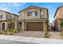 Two-story house with brown garage door and landscaping at 4348 Bayley Skye Ave, Las Vegas, NV 89141