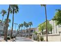 gated community entrance with palm trees at 3125 N Buffalo Dr # 2104, Las Vegas, NV 89128