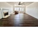 Living room with wood-look flooring, white walls, and windows at 611 E Fairway Rd, Henderson, NV 89015