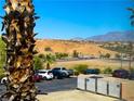 View of parking lot, desert landscape, and mountains in the background at 555 Highland Dr # 223, Mesquite, NV 89027