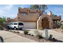 Two-story stucco home with arched entry and attached garage at 920 Vista Del Sol Ct, Mesquite, NV 89027