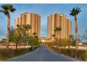 Two high-rise condominium buildings with palm trees and landscaped grounds at 8255 S Las Vegas Blvd # 1521, Las Vegas, NV 89123