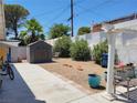 Backyard with shed, gravel, and patio with pergola at 1680 Sombrero Dr, Las Vegas, NV 89169