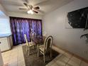 Charming dining area with glass table and four chairs, complemented by purple curtains at 1440 Vegas Valley Dr # 14, Las Vegas, NV 89169