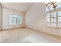 Bright and airy living room featuring vaulted ceilings and large windows at 2063 Sapphire Valley Ave, Henderson, NV 89074