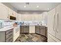 Updated kitchen with gray and white cabinets, tile backsplash and flooring at 262 Big Horn Dr, Boulder City, NV 89005