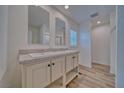 Bathroom with double vanity, large mirrors, and a walk-in shower at 4401 E Kellogg Rd, Pahrump, NV 89061