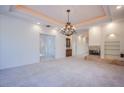 Spacious living room featuring a fireplace and chandelier at 2951 Aruba Ct, Las Vegas, NV 89121