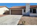 Single story home with brown garage door and tile roof at 1617 Joshua Tree Ct, Las Vegas, NV 89108