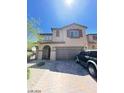 Two-story house with a two-car garage and landscaping at 2409 W Gilmore Ave, North Las Vegas, NV 89032