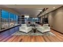 Luxury living room with hardwood floors, city views, and modern furniture at 4525 Dean Martin Dr # 2200, Las Vegas, NV 89103