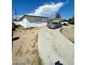 Home exterior with a driveway and car parked at 1932 Lawry Ave, North Las Vegas, NV 89032