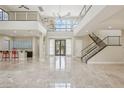 Spacious great room with high ceilings, marble floors, and modern staircase at 101 San Martino Pl, Henderson, NV 89011