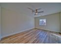 Bright bedroom featuring wood-look flooring and a ceiling fan at 5130 Valero Ct, Pahrump, NV 89060