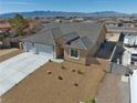 Single-story house with a three-car garage and desert landscaping at 6440 Montclair St, Pahrump, NV 89061