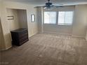 Spacious bedroom with carpeted floor, ceiling fan, and large windows at 3639 Bufflehead St, Las Vegas, NV 89122