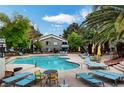 Inviting community pool with lounge chairs and palm trees at 3131 Key Largo Dr # 104, Las Vegas, NV 89120