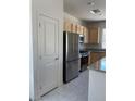 Kitchen with stainless steel appliances and light wood cabinets at , North Las Vegas, NV 89086