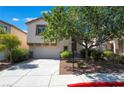 Two-story house with a landscaped yard and attached garage at 5543 Cortu Ave, Las Vegas, NV 89141