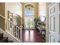 Bright entryway with double doors, hardwood floors, and elegant chandelier at 3047 Hills Of Gold Ct, Henderson, NV 89052