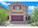 Two-story house with burgundy garage door and stone driveway at 5325 Appledale St, Las Vegas, NV 89166