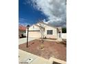 Single-story house with a two-car garage and landscaped yard at 336 River Glider Ave, North Las Vegas, NV 89084