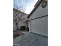 House exterior featuring a two-car garage and front yard at 9617 Pine River Ln, Las Vegas, NV 89123