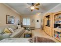 Inviting living room with comfortable seating, built-in entertainment center, and tile floors at 519 Cypress Links Ave, Henderson, NV 89012