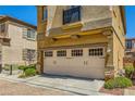 Beige two-car garage with decorative windows at 11322 Corsica Mist Ave, Las Vegas, NV 89135