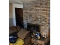 Living room with brick fireplace and mantle at 4200 Coran Ln, Las Vegas, NV 89108