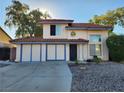 Two-story house with a two-car garage and landscaped front yard at 1601 Paloma Ave, Laughlin, NV 89029