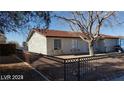 Ranch style home with a red tile roof and a fenced yard at 915 Major Ave, Henderson, NV 89015