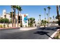 Entrance to a condo community with landscaping and signage at 6250 W Flamingo Rd # 102, Las Vegas, NV 89103