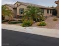 House exterior with palm trees and desert landscaping at 936 Via Vannucci Way, Henderson, NV 89011