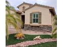 One-story home with stone accents and wood shutters at 936 Via Vannucci Way, Henderson, NV 89011