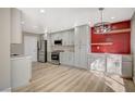 Modern kitchen with gray cabinets, quartz countertops, and stainless steel appliances at 8753 Sundial Dr, Las Vegas, NV 89134