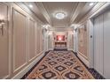 Elegant hallway with patterned carpet and chandelier at 2000 N Fashion Show Dr # 6006, Las Vegas, NV 89109