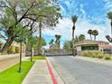 Gated community entrance with guardhouse and lush landscaping at 2451 Tour Edition Dr, Henderson, NV 89074