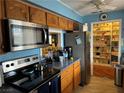 Kitchen features stainless steel appliances and wood cabinets at 2315 Beverly Way, Las Vegas, NV 89104