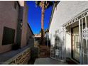 Small backyard with a gate and a palm tree at 4224 Estaban Ct, Las Vegas, NV 89110