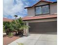 Two-story house with brown garage door and terracotta roof tiles at 6444 Deadwood Rd, Las Vegas, NV 89108