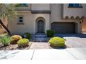 House exterior featuring a modern design, landscaped walkway, and two-car garage at 9643 Ponderosa Skye Ct, Las Vegas, NV 89166