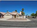 Front view of a single-story house with a yard at 5216 Del Lago Dr, Las Vegas, NV 89130