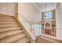 View from the stairs to the living room and fireplace at 5897 Passing Breeze Ct, Las Vegas, NV 89118