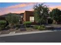 Stunning exterior view of a single story home at sunset at 10057 Regency Canyon Way, Las Vegas, NV 89148