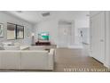 Spacious living room with white couch and hardwood floors at 4792 Essen Ct, Las Vegas, NV 89147