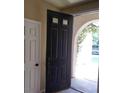 Front entry with black door and view to backyard at 1700 Ravanusa Dr, Henderson, NV 89052