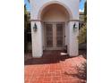 Home features a double door entry with decorative iron and brick walkway at 2873 Knoxville Ct, Henderson, NV 89052