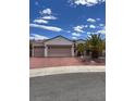 Single story home with three car garage and desert landscaping at 2873 Knoxville Ct, Henderson, NV 89052